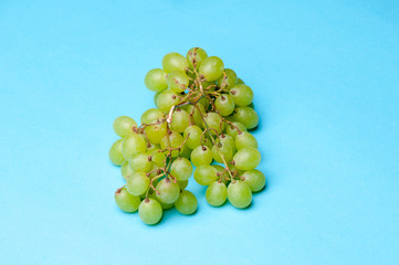 Green grapes on a blue background