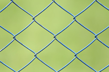 Fototapeta premium wire mesh or steel cage of green lawn in the garden.