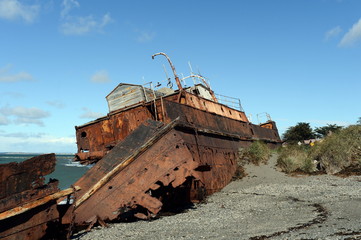 Fototapeta na wymiar Rusty ship on the shore of the Strait of Magellan in the village of San Gregorio.