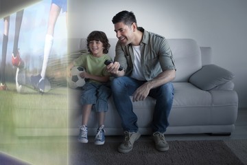 Naklejka premium Football players tacakling for the ball on pitch