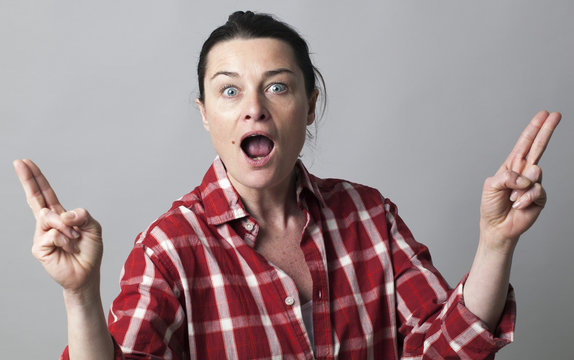 surprised woman showing fingers like fun guns for female power
