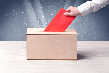 Ballot box with person casting vote
