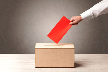 Ballot box with person casting vote