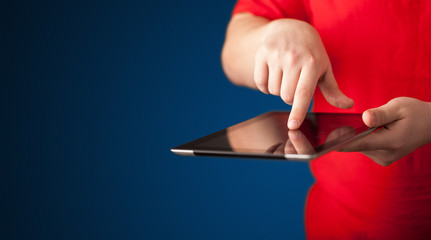 Close up of hand holding digital touchpad tablet device