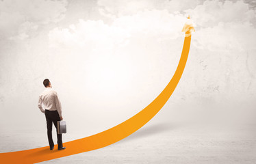 Business person standing on orange arrow