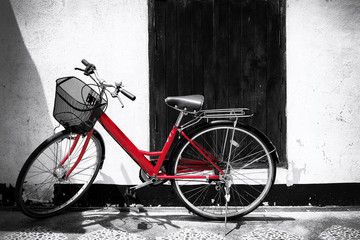 Fototapeta na wymiar Black and white photo of red bicycle - vintage film grain filter effect styles