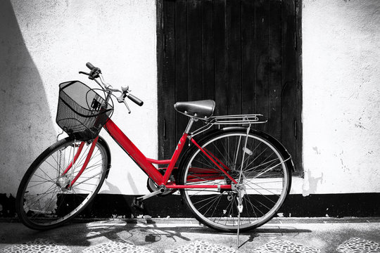 Black and white photo of red bicycle - vintage film grain filter effect styles