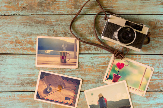 Photo album of remembrance, love and nostalgia in summer journey trip on wood table. instant photo of camera - vintage and retro style