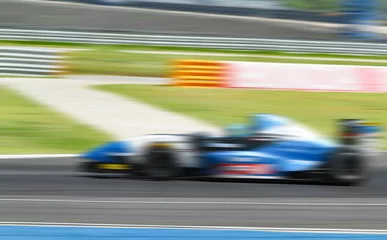 Papier Peint photo Lavable Voitures rapides car racing on the road with motion blur and Radial blu