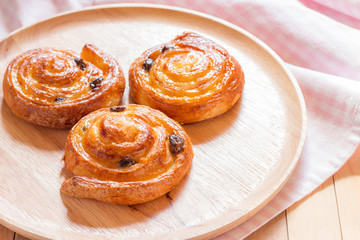 Cinnamon and raisin roll bun,still life style from above.