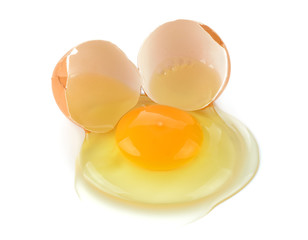 A cracked egg with an egg shell, egg yolk and egg white