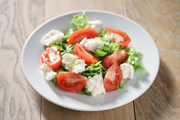 summer light salad with tomatoes, mozzarella and rocket leaves