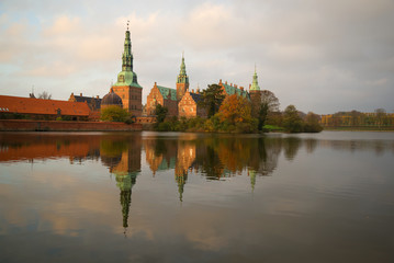 Frederiksborg castle in the light of the setting sun on the november evening. Denmark