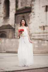 Beautiful young bride with bridal bouquet on the background church