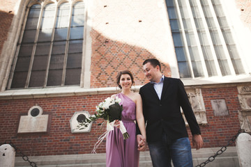 Fototapeta premium Elegant beautiful wedding couple posing near a church. Krakow