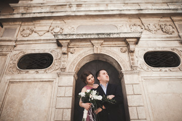 Fototapeta na wymiar Elegant beautiful wedding couple posing near a church. Krakow