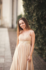 Beautiful girl with long hair posing near tree in vavel Krakow