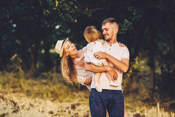 Father, mother and daughter in the park