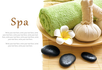 Beautiful spa composition. Herbal balls and towel in the bowl. Pebbles and cosmetics close up