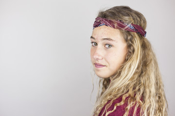 Close up portrait of smiling pretty teenager with curly hair and