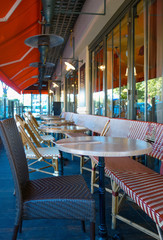 Street view of a coffee terrace with tables and chairs in europe