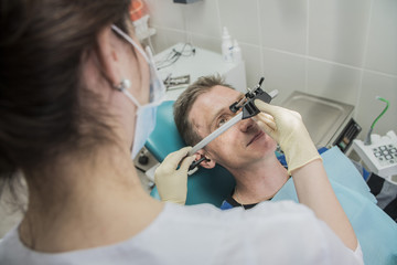 dentist doctor puts on the patient dental front arc