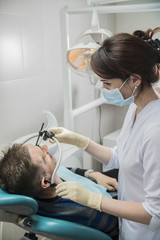 dentist doctor puts on the patient dental front arc