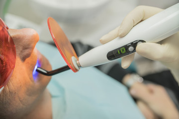 examination of the patient in dentistry by using a photopolymerization lamp