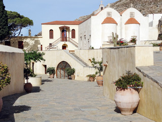 traditional old monastery among bougainvillaea in Greece