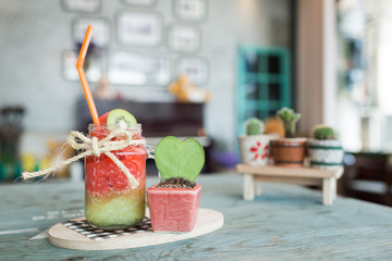Fruit Smoothie on wooden table on blurred background © yingtanthawarak