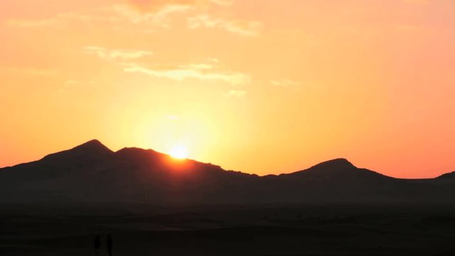 Sunrise in Sahara desert with Atlas mountains view time lapse. Filmed in Morocco