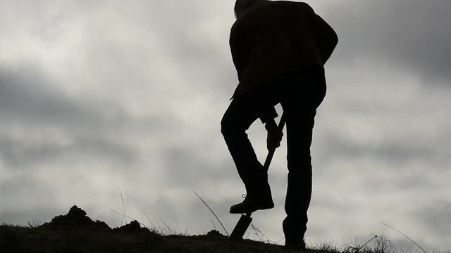 man digging with the spade and wipes the sweat slow motion