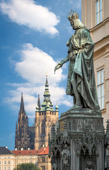Naklejka premium Prague, Czech Republic - May 28, 2016: King Charles IV monument at Crusaders' Square in Prague. St. Vitus cathedral at Prague castle in background. 