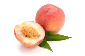 Ripe peaches with leaves.