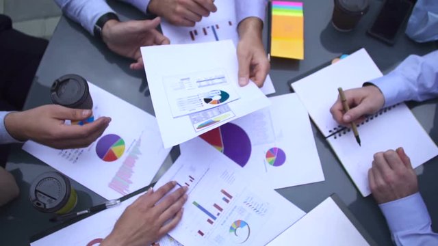 Business chart is placed on the table.