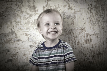Fototapeta premium Smiling boy at the bright wall