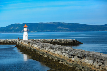 Old lighthouse on the pier in the twilight 