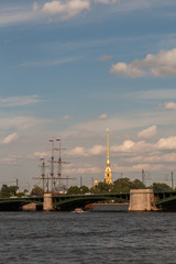 Fototapeta na wymiar The spire of the Peter and Paul Cathedral, Birgevoy Bridge and the River Neva summer day.