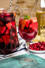 Summer home wine with fruits, sangria cocktail, dogwood berries plate