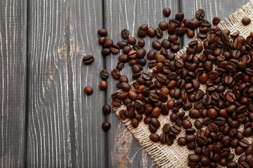 Roasted coffee beans on wooden background
