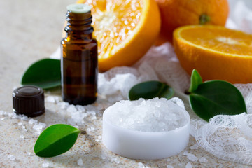 Bottle of orange essential oil aromatherapy and salt on brown st