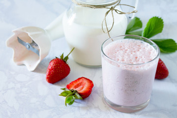 Fresh summer drink smoothies with strawberries on a gray stone b