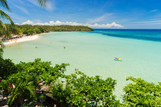 Giant beach of white sand under blue tropical sky