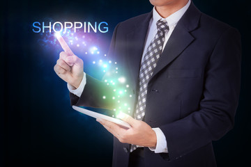 Businessman holding tablet with pressing shopping. internet and networking concept