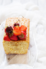 Fruitcake with strawberry and cherry topping