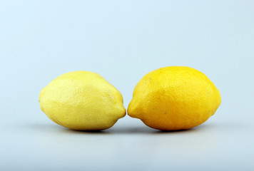 Two ripe yellow lemons in studio