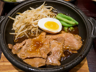 pork with egg and vegetables on hot plate