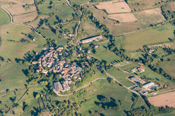 Birds eye view of cultivated land, roads and private houses