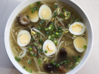 Soup Japanese style with noodles, bean sprouts, quail eggs and s