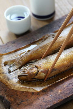 simmered ayu ( sweetfish ) with japanese pepper, and sake ( japanese rice wine )